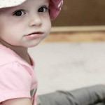 young toddler wearing hat looking at camera